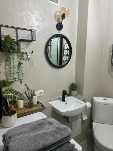 a bathroom with a sink and a mirror at Naomi apartaments in Saldus
