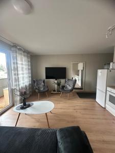 a living room with a couch and a table at Naomi apartaments in Saldus
