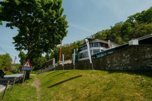 a house on top of a hill with a building at LPM Sporthotel Durbuy in Durbuy