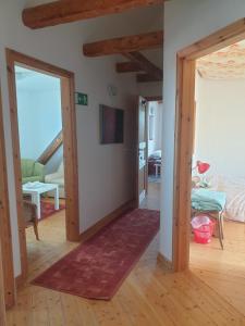 a hallway with a door open to a living room at Ferienhaus am DEISTER in Barsinghausen