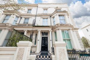 a white house with a black door at NOX Kensington in London