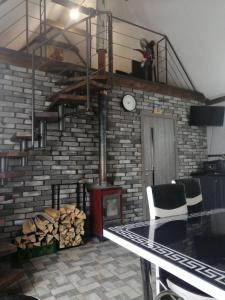 a room with a brick wall with a fire place at Котедж ,,Чудовий" з Чаном in Novaya Greblya