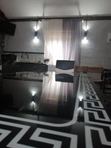 a room with a table and a window with a chair at Котедж ,,Чудовий" з Чаном in Novaya Greblya
