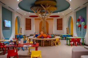 a room with tables and chairs with balloons on the ceiling at Armella Hill Hotel in Side
