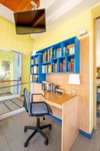 an office with a desk with a chair and bookshelves at Hotel Marina in Fano