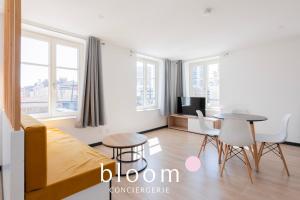 a bedroom with a bed and a table and chairs at Le Soleil du Marché central in Nancy