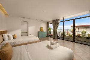 a bedroom with two beds and a large window at Sora Villa, Huge Swimming Pool, Private Sauna & Elevator Access in Danang +38 photos
