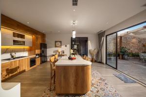 a kitchen with a large island in the middle of a room at Sora Villa, Huge Swimming Pool, Private Sauna & Elevator Access in Danang