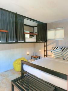 a bedroom with a bed and a bunk bed at Beach People Hostel Bantayan Island in Ocoy