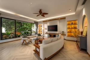 a living room with a couch and a table at Sora Villa, Huge Swimming Pool, Private Sauna & Elevator Access in Danang