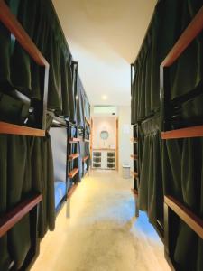 a hallway with green bunk beds in a room at Beach People Hostel Bantayan Island in Ocoy