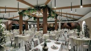 a banquet hall with white tables and chairs and plants at Motel Dani in Nova Bila