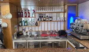 a kitchen with a bar sign on the wall at Hotel Bel Air Frontemare in Rimini