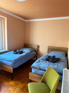 a room with two beds and a chair in it at Ferienhaus Mila in Löbau