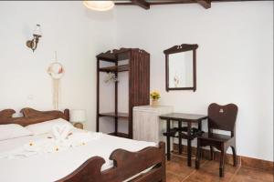 ein Schlafzimmer mit einem Bett, einem Schreibtisch und einem Spiegel in der Unterkunft Casa Pescareasca - Complex Plaja Golf in Corbu