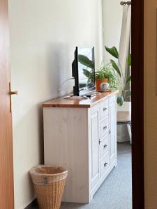 a room with a desk with a computer on it at Hotel Katerberg - Room and Kitchen in Ahlefeld