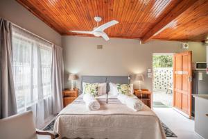a bedroom with a bed with a ceiling fan at 30 on Oatlands Accommodation Makhanda Grahamstown in Grahamstown