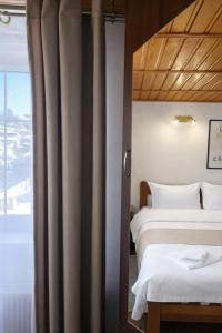 a hotel room with two beds and a window at Heaven Boutique in Pucioasa