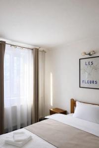 a hotel room with two beds and a window at Heaven Boutique in Pucioasa