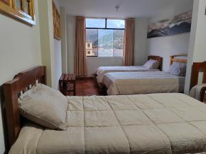 a hotel room with two beds and a window at Alma Andina Lodge in Huaraz +28 photos