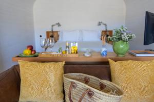 a living room with a couch with two pillows and a table at Casa do Rio - Douro Wine Hotel by Vallado in Vila Nova de Foz Coa