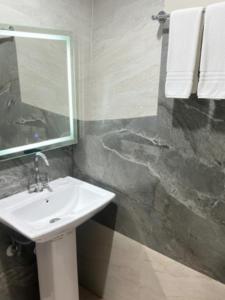 a bathroom with a sink and a mirror at Shri Radha Kripa Dham in Rādha Kund +11 photos