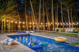a swimming pool with inflatable balls in the water at Taean Red Balloon Pension in Taean