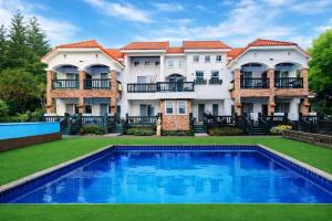 a large house with a swimming pool in the yard at Taean Red Balloon Pension in Taean