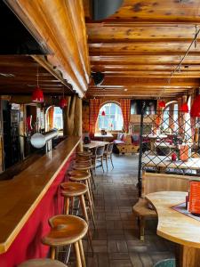 a bar with wooden stools in a restaurant at Linnenkerlstube in Willingen