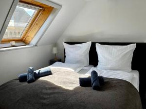 a bedroom with a bed with two pairs of socks on it at Fewo Charlotte in Weimar