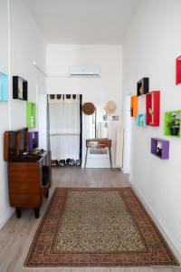 a living room with a tv and a rug at Mirella's House in Padova