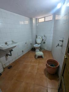a bathroom with a toilet and a sink at Hotel Neelkamal in Indore