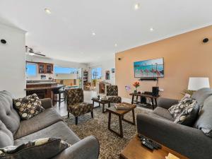 a living room with couches and a piano at Villa Savannah in Savaneta