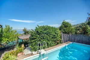 a swimming pool in the backyard of a house at GOCCE VILLAS - Sunshine Villa in Massa Lubrense