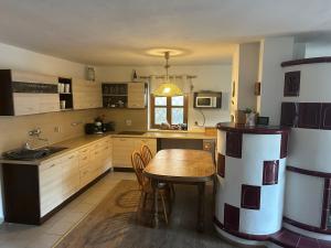 a kitchen with a wooden table and a dining room at Andělský sklípek in Dolní Věstonice +21 photos