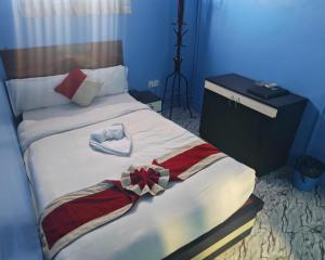 a bed with a dresser and a bow on it at Hotel Aahar chitawan in Bharatpur