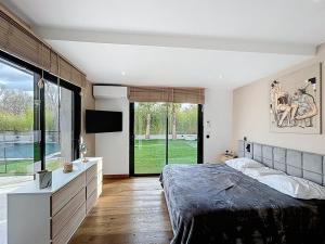 a bedroom with a large bed and a television in it at Maison de prestige à Grimaud in Grimaud +16 photos