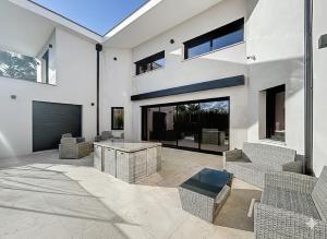 a large white house with a table and chairs at Maison de prestige à Grimaud in Grimaud