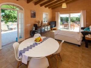 a living room with a white table and chairs at Finca Bassa Serra in Santanyi +10 photos