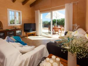 a living room with a couch and a tv at Finca Bassa Serra in Santanyi