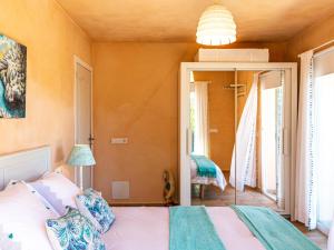 a bedroom with a bed and a mirror at Finca Bassa Serra in Santanyi