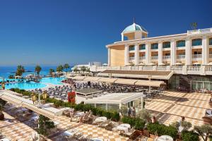 a resort with a swimming pool and a building at Litore Resort Hotel & Spa - Ultra All Inclusive in Okurcalar