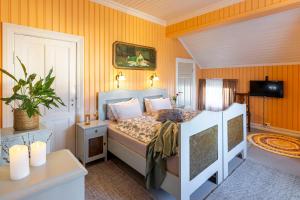 a bedroom with a bed and a television in a room at Negarden 1897 in Åsnes