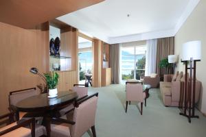 a living room with a table and chairs at Jinling Resort Nanjing in Nanjing