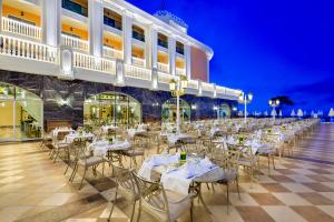 a banquet hall with white tables and chairs at Litore Resort Hotel & Spa - Ultra All Inclusive in Okurcalar
