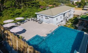 an overhead view of a swimming pool with umbrellas and a building at Cote d'Or Retreat in Anse Volbert Village