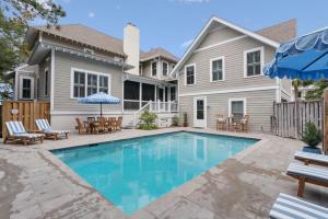 a swimming pool in front of a house at Sunset Peak - 1928 Ocean Road in Saint Simons Island