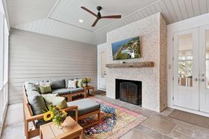 a living room with a couch and a fireplace at Sunset Peak - 1928 Ocean Road in Saint Simons Island