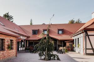 a courtyard of a building with a christmas tree at Viešbutis DYVAI in Kupiškis