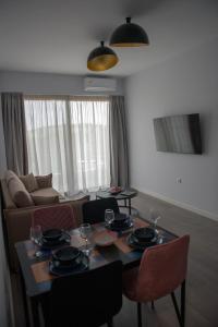 a living room with a table and chairs and a couch at The ViewPoint VP2 - Το διαμάντι της θέας in Mytilene